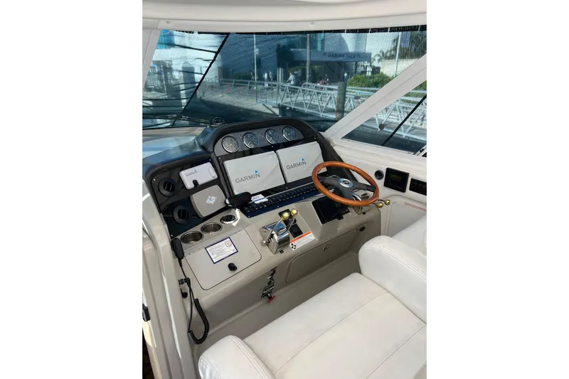 Bula Bula Yacht Photos Pics 2006 Sea Ray 40 Motor Yacht helm with Garmin navigation and wood steering wheel.
