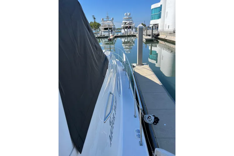 Bula Bula Yacht Photos Pics 2006 Sea Ray 40 Motor Yacht docked at a marina, reflecting in calm water.