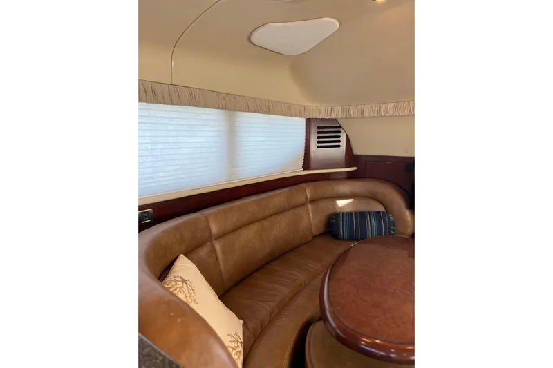Bula Bula Yacht Photos Pics Interior of 2006 Sea Ray 40 Motor Yacht with leather seating and wooden table.