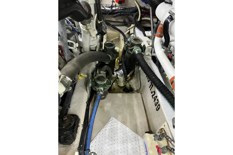 Bula Bula Yacht Photos Pics Engine room of a 2006 Sea Ray 40 Motor Yacht, showcasing hoses and mechanical components.