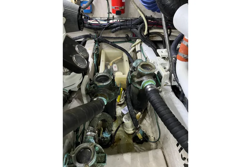 Bula Bula Yacht Photos Pics Engine room of a 2006 Sea Ray 40 Motor Yacht with visible hoses and components.