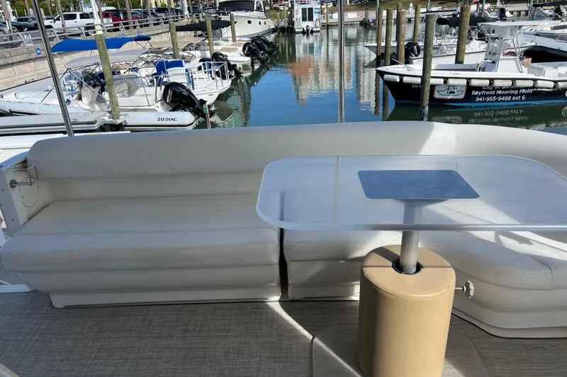 Bula Bula Yacht Photos Pics 2006 Sea Ray 40 Motor Yacht interior with white seating and table, docked at marina.