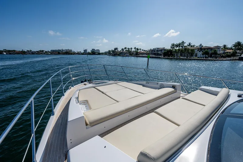  Yacht Photos Pics Azimut 55S 2014 yacht with sun loungers on deck, cruising in sunny waters.