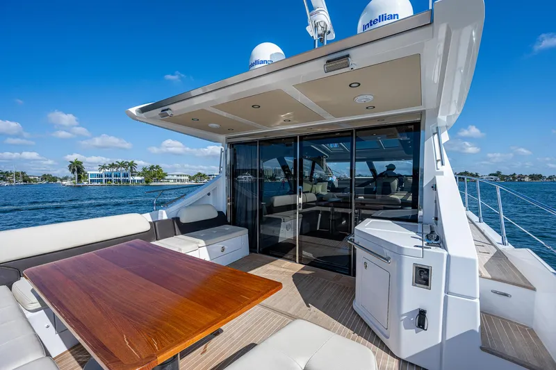  Yacht Photos Pics Luxurious 2014 Azimut 55S yacht deck with seating and table, overlooking serene waters.
