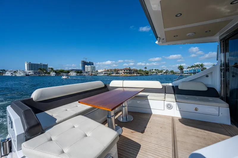  Yacht Photos Pics Luxurious 2014 Azimut 55S yacht deck with seating, table, and scenic waterfront view.