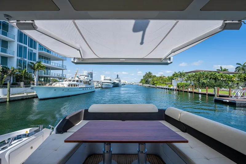  Yacht Photos Pics Luxurious 2014 Azimut 55S yacht with elegant seating, docked in a scenic marina.
