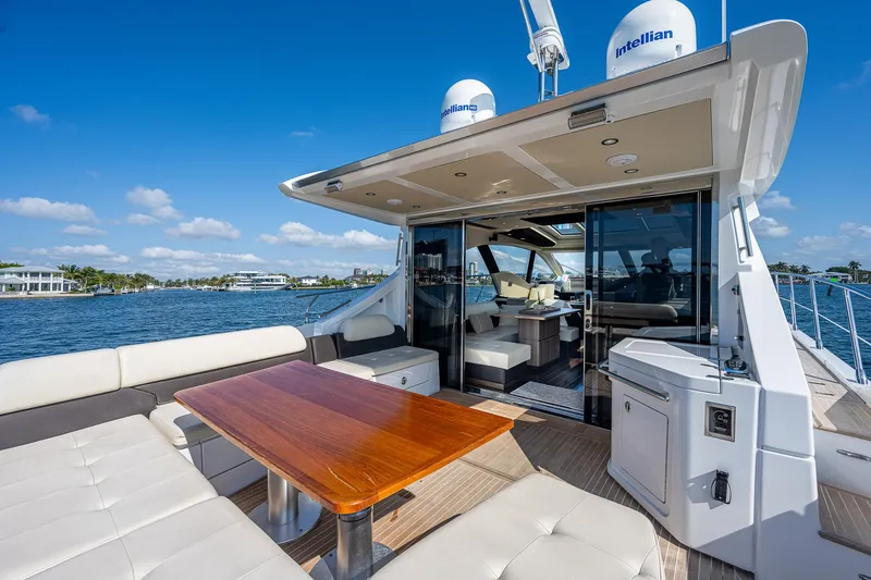  Yacht Photos Pics 2014 Azimut 55S yacht with luxurious outdoor seating and dining area on a sunny day.