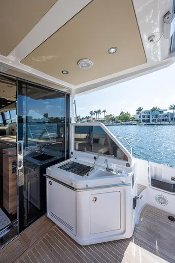  Yacht Photos Pics 2014 Azimut 55S yacht deck with outdoor kitchen, overlooking waterfront homes.