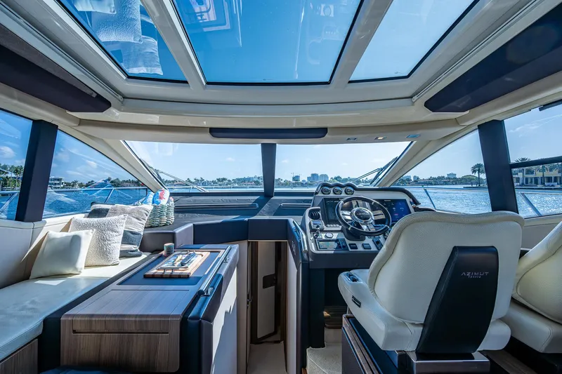  Yacht Photos Pics Interior view of 2014 Azimut 55S yacht with luxurious seating and panoramic windows.