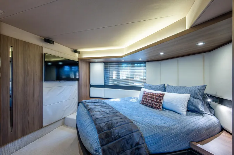  Yacht Photos Pics Luxurious bedroom interior of a 2014 Azimut 55S yacht with modern design and cozy bedding.