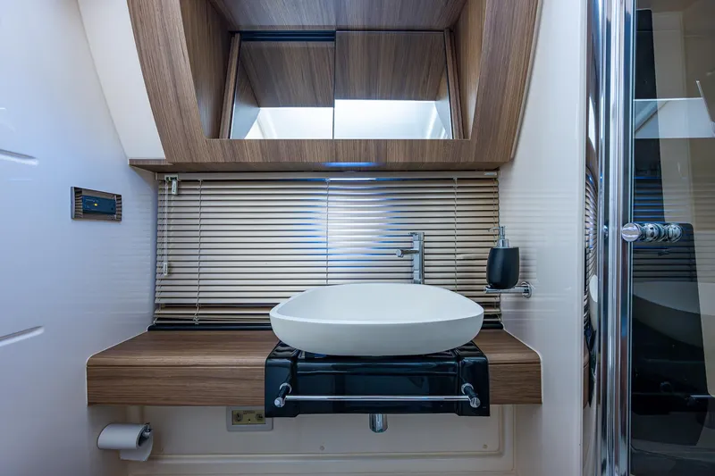  Yacht Photos Pics Luxurious bathroom interior of 2014 Azimut 55S yacht with modern sink and wooden accents.