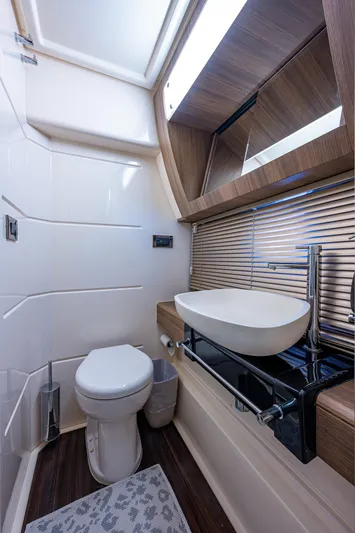  Yacht Photos Pics Luxurious bathroom in 2014 Azimut 55S yacht with modern fixtures and elegant design.