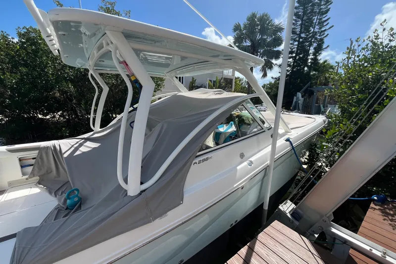  Yacht Photos Pics 2020 World Cat 296 DC boat docked, featuring a covered cabin and sleek design.