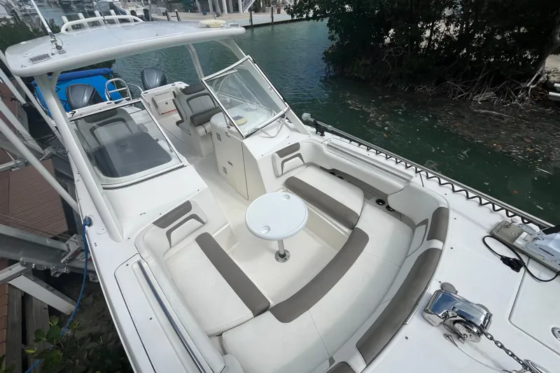  Yacht Photos Pics 2020 World Cat 296 DC boat with spacious seating and modern design docked by water.