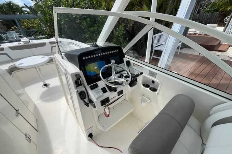  Yacht Photos Pics 2020 World Cat 296 DC boat cockpit with steering wheel and navigation display.