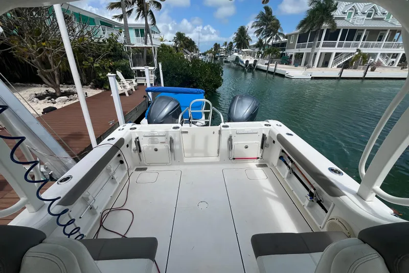  Yacht Photos Pics 2020 World Cat 296 DC boat docked in a scenic waterfront setting.