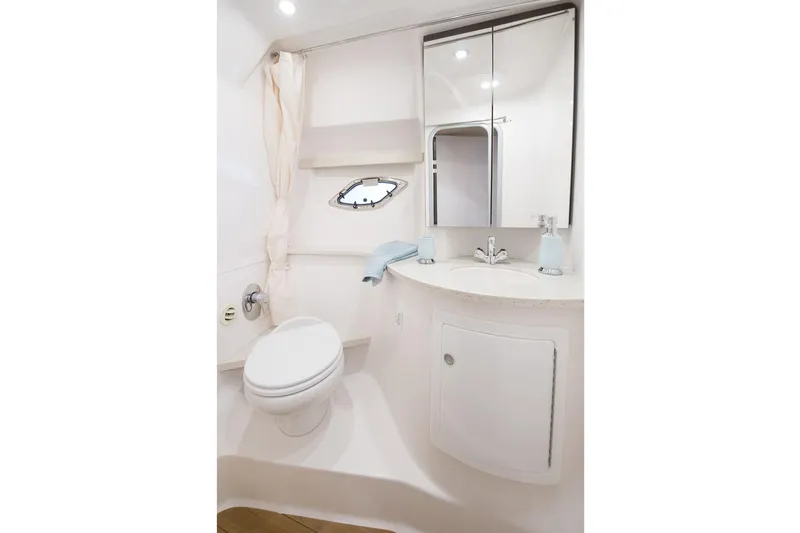  Yacht Photos Pics Manufacturer Provided Image: 2017 Regal 35 Sport Coupe bathroom with toilet, sink, mirror, and porthole.