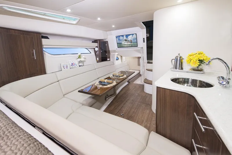  Yacht Photos Pics Manufacturer Provided Image: Interior of 2017 Regal 35 Sport Coupe yacht with modern seating, dining area, and kitchenette.
