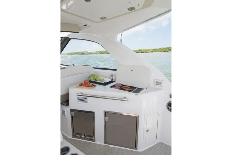  Yacht Photos Pics Manufacturer Provided Image: 2017 Regal 35 Sport Coupe yacht interior with a built-in grill and storage.