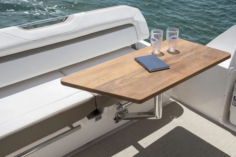  Yacht Photos Pics Manufacturer Provided Image: 2017 Regal 35 Sport Coupe boat interior with wooden table and seating.