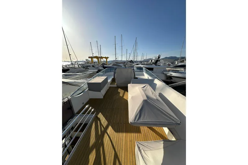  Yacht Photos Pics 2014 Fairline Squadron 65 yacht deck with covered seating, docked in a marina.