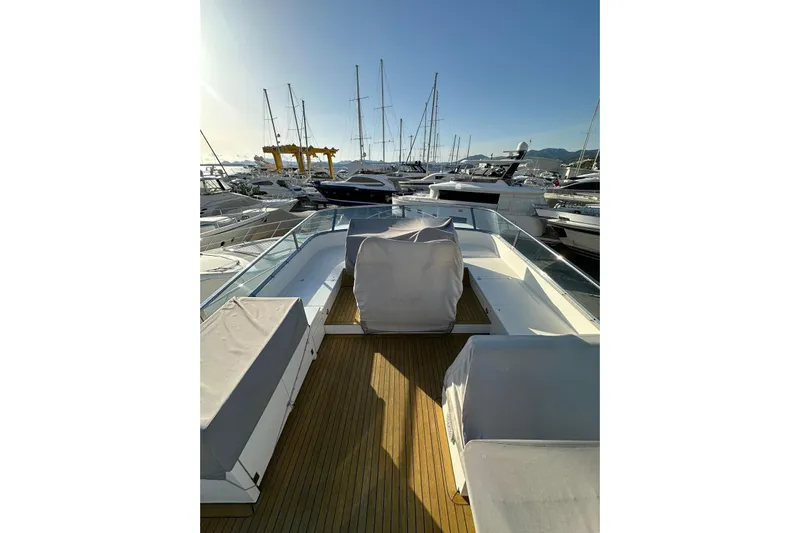  Yacht Photos Pics 2014 Fairline Squadron 65 yacht deck with covered seating, docked in a marina.