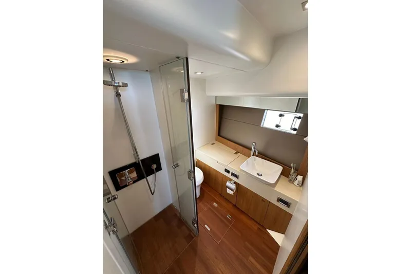  Yacht Photos Pics Luxurious bathroom in 2014 Fairline Squadron 65 yacht with modern fixtures and wooden accents.