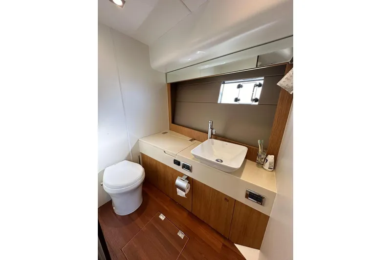  Yacht Photos Pics Luxurious bathroom in 2014 Fairline Squadron 65 yacht with modern fixtures and wood accents.