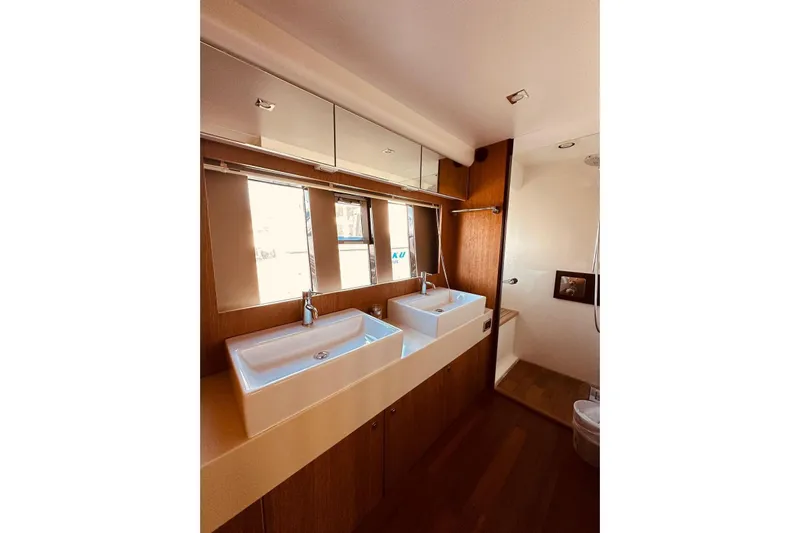  Yacht Photos Pics Luxurious bathroom interior of 2014 Fairline Squadron 65 yacht with dual sinks and modern design.