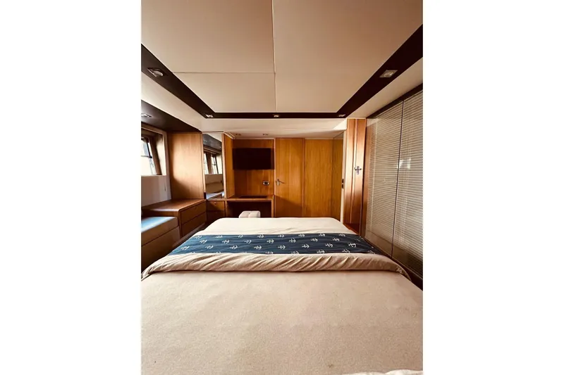  Yacht Photos Pics Luxurious bedroom interior of 2014 Fairline Squadron 65 yacht with elegant wood finishes.