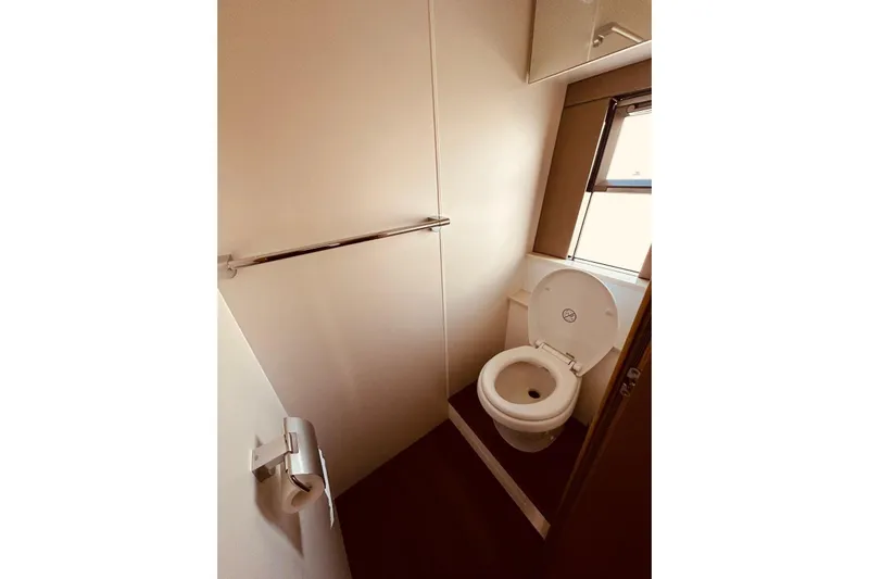  Yacht Photos Pics Bathroom interior of 2014 Fairline Squadron 65 yacht, featuring a toilet and window.