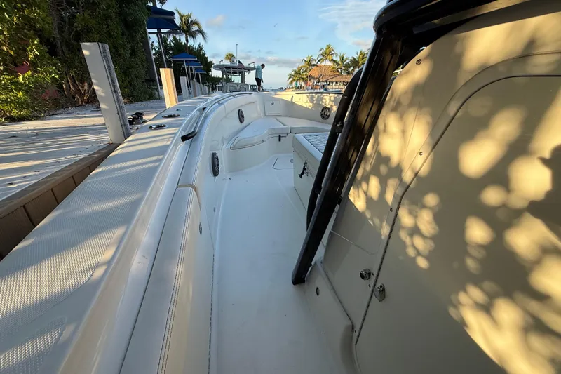  Yacht Photos Pics 2015 Hydra-Sports 3400 CC boat docked, sunlit deck, surrounded by tropical scenery.