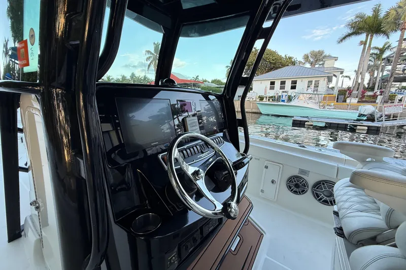  Yacht Photos Pics 2015 Hydra-Sports 3400 CC boat cockpit with steering wheel and navigation screens.