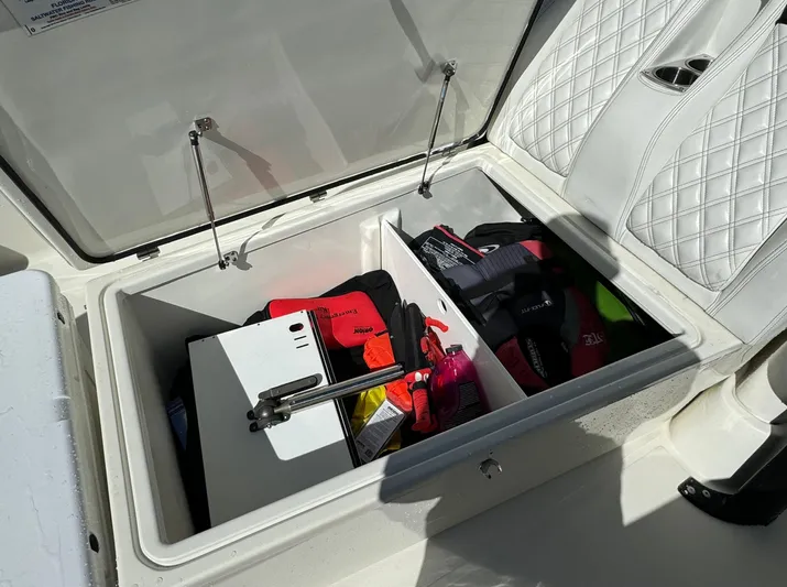  Yacht Photos Pics Storage compartment on a 2015 Hydra-Sports 3400 Center Console boat, containing safety gear.