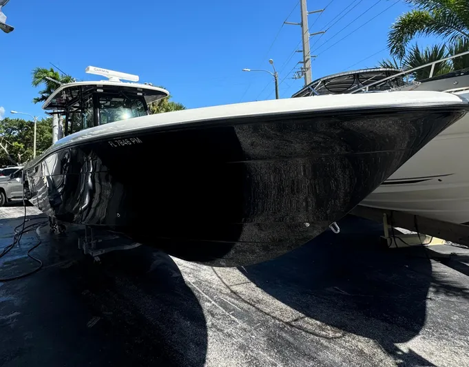  Yacht Photos Pics 2015 Hydra-Sports 3400 Center Console boat, black hull, parked outdoors under clear blue sky.