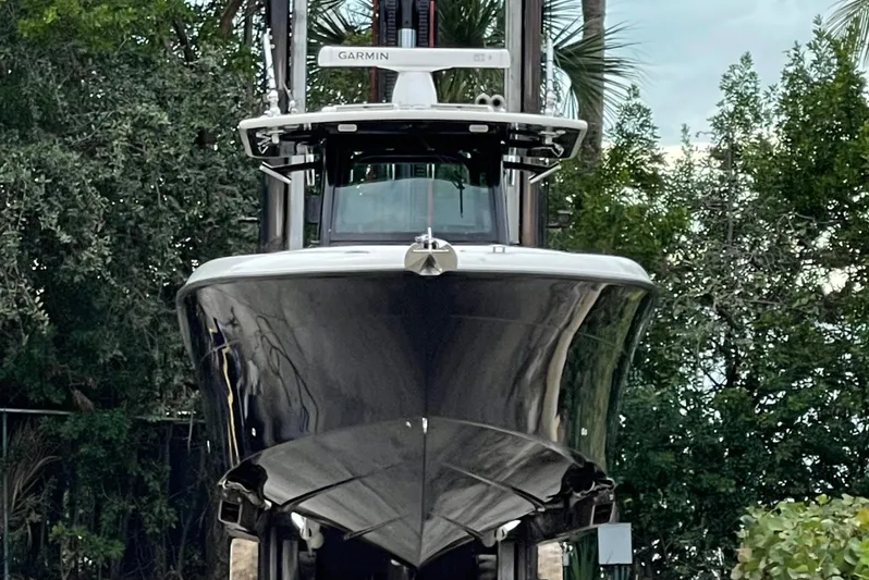  Yacht Photos Pics 2015 Hydra-Sports 3400 Center Console boat with Garmin equipment, front view amidst trees.