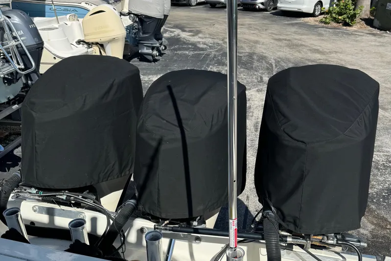  Yacht Photos Pics Three covered outboard motors on a 2015 Hydra-Sports 3400 Center Console boat.