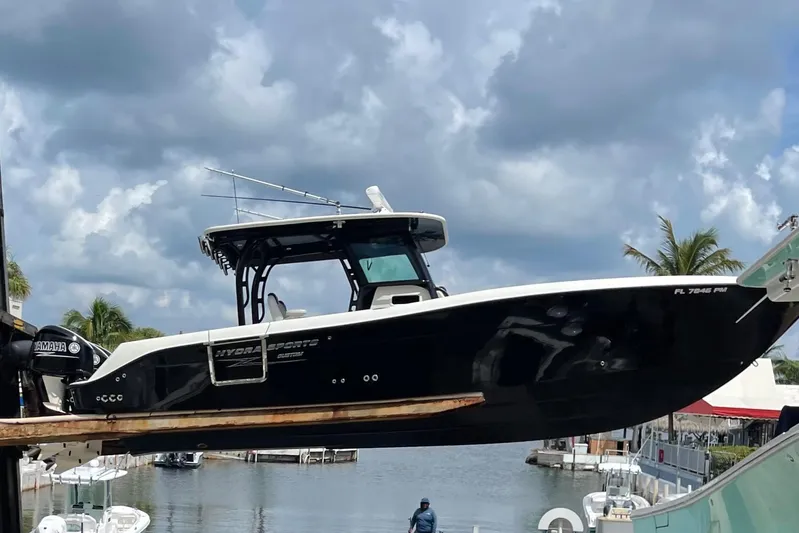  Yacht Photos Pics 2015 Hydra-Sports 3400 Center Console boat lifted at marina, cloudy sky background.