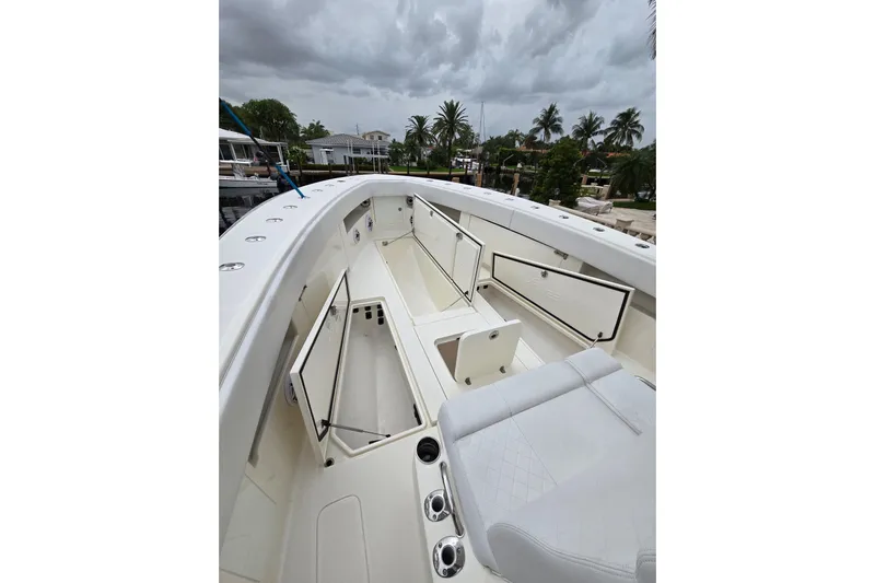  Yacht Photos Pics 2019 SeaVee 390Z boat interior with open storage compartments and seating under cloudy skies.