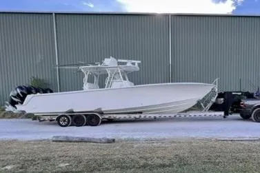  Yacht Photos Pics 2019 SeaVee 390Z boat on trailer, parked outdoors near a large building.