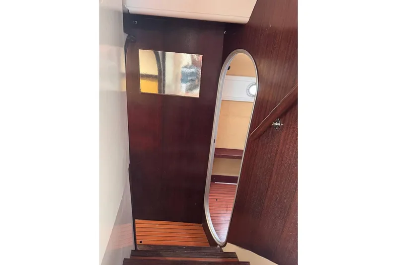  Yacht Photos Pics Interior view of 1998 Fountaine Pajot Bahia 46 yacht with wooden stairs and mirror.