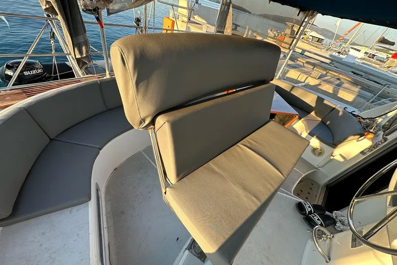  Yacht Photos Pics 1998 Fountaine Pajot Bahia 46 yacht cockpit with cushioned seating and steering wheel.