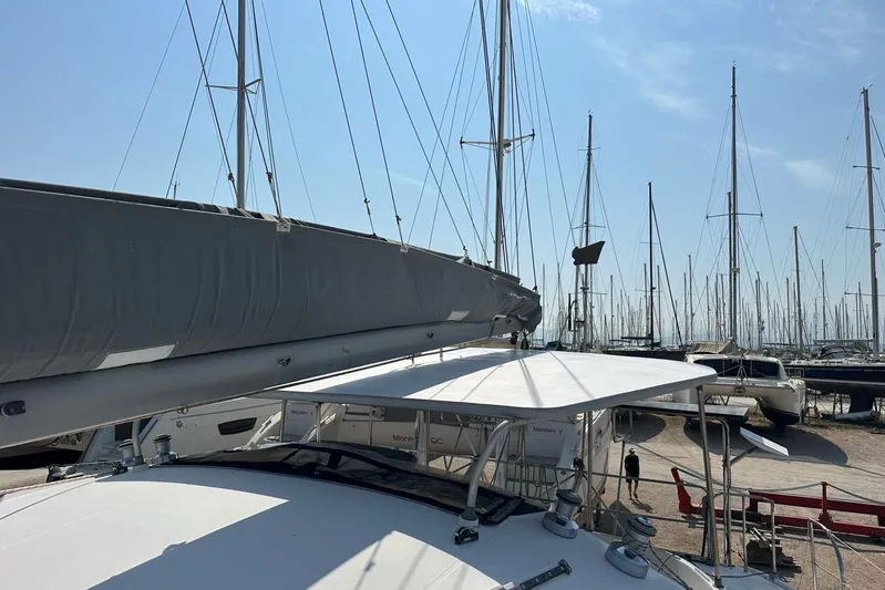  Yacht Photos Pics 1998 Fountaine Pajot Bahia 46 catamaran in a marina, surrounded by sailboats under a clear sky.