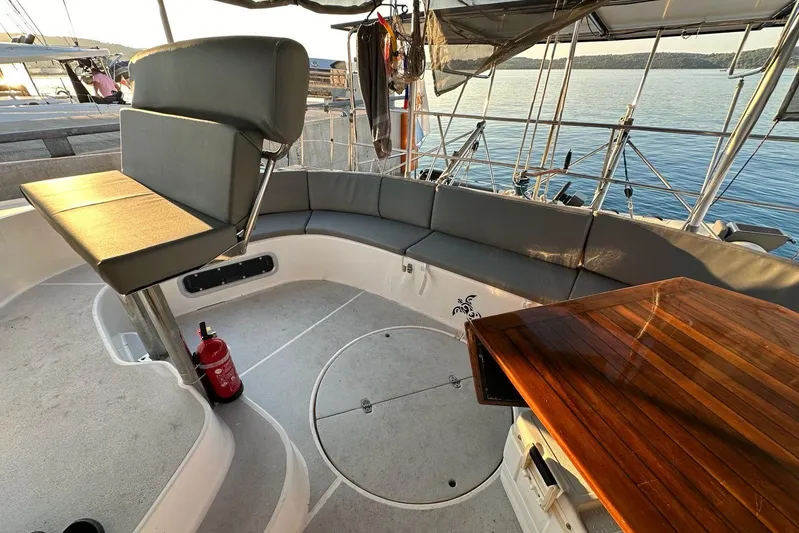  Yacht Photos Pics Spacious cockpit of 1998 Fountaine Pajot Bahia 46 catamaran with seating and wooden table.