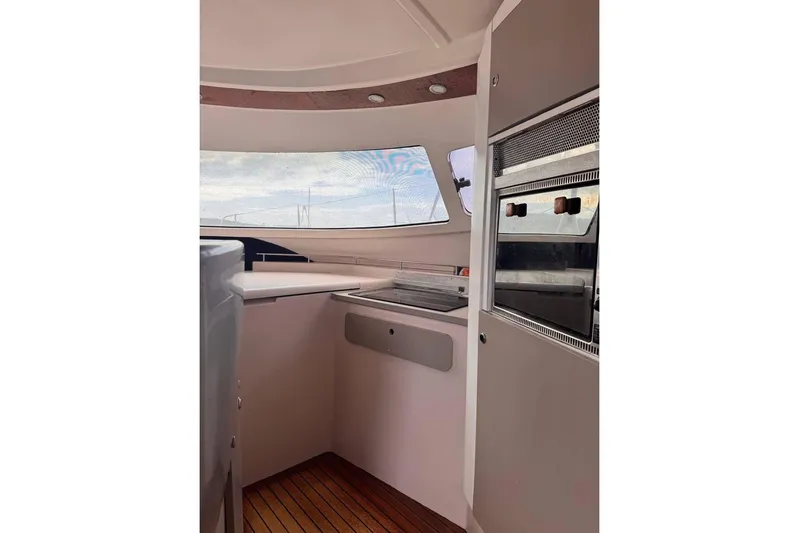  Yacht Photos Pics Interior of 1998 Fountaine Pajot Bahia 46 catamaran, featuring modern kitchen and wooden flooring.