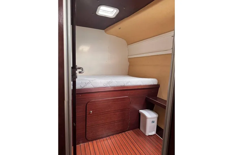 Yacht Photos Pics Cabin interior of 1998 Fountaine Pajot Bahia 46 catamaran with bed and wooden flooring.