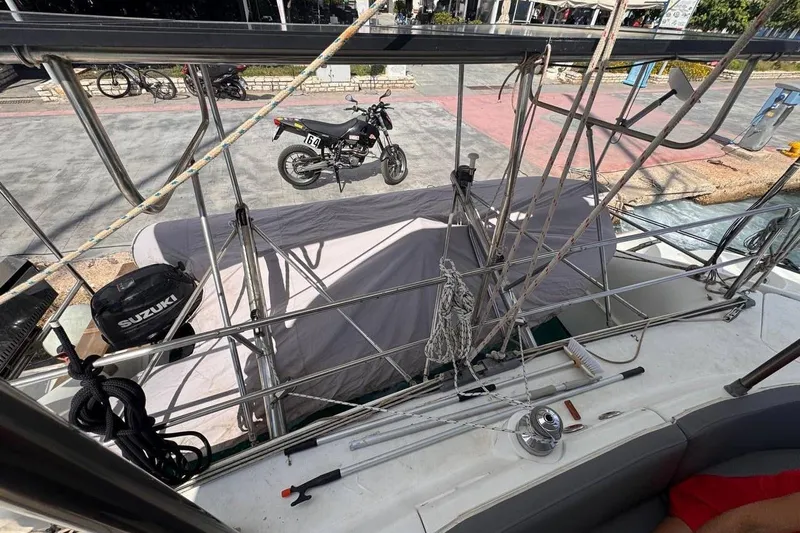  Yacht Photos Pics 1998 Fountaine Pajot Bahia 46 catamaran deck with Suzuki outboard motor and motorcycle nearby.