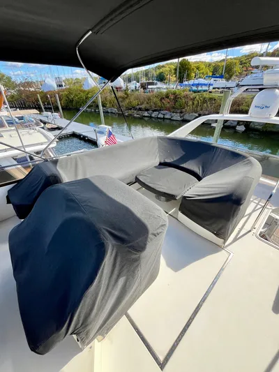 Way To Go Yacht Photos Pics 1999 Viking Sport Cruisers 60 Flybridge with covered seating area on deck.