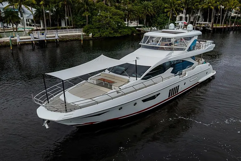 Lucky 7 Yacht Photos Pics Luxury 2017 Azimut 80 yacht cruising on a serene waterway, surrounded by lush greenery.
