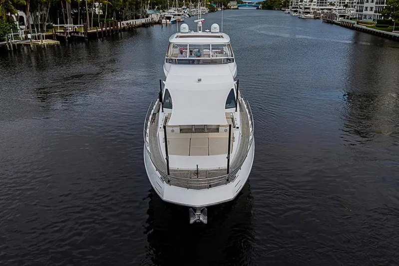 Lucky 7 Yacht Photos Pics 2017 Azimut 80 yacht cruising on a serene waterway, surrounded by lush greenery.